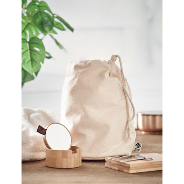 A beige recycled cotton drawstring bag with a natural and minimalist aesthetic ideal for eco conscious use